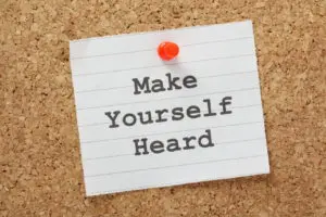 A note pinned to a corkboard reads "Make Yourself Heard."