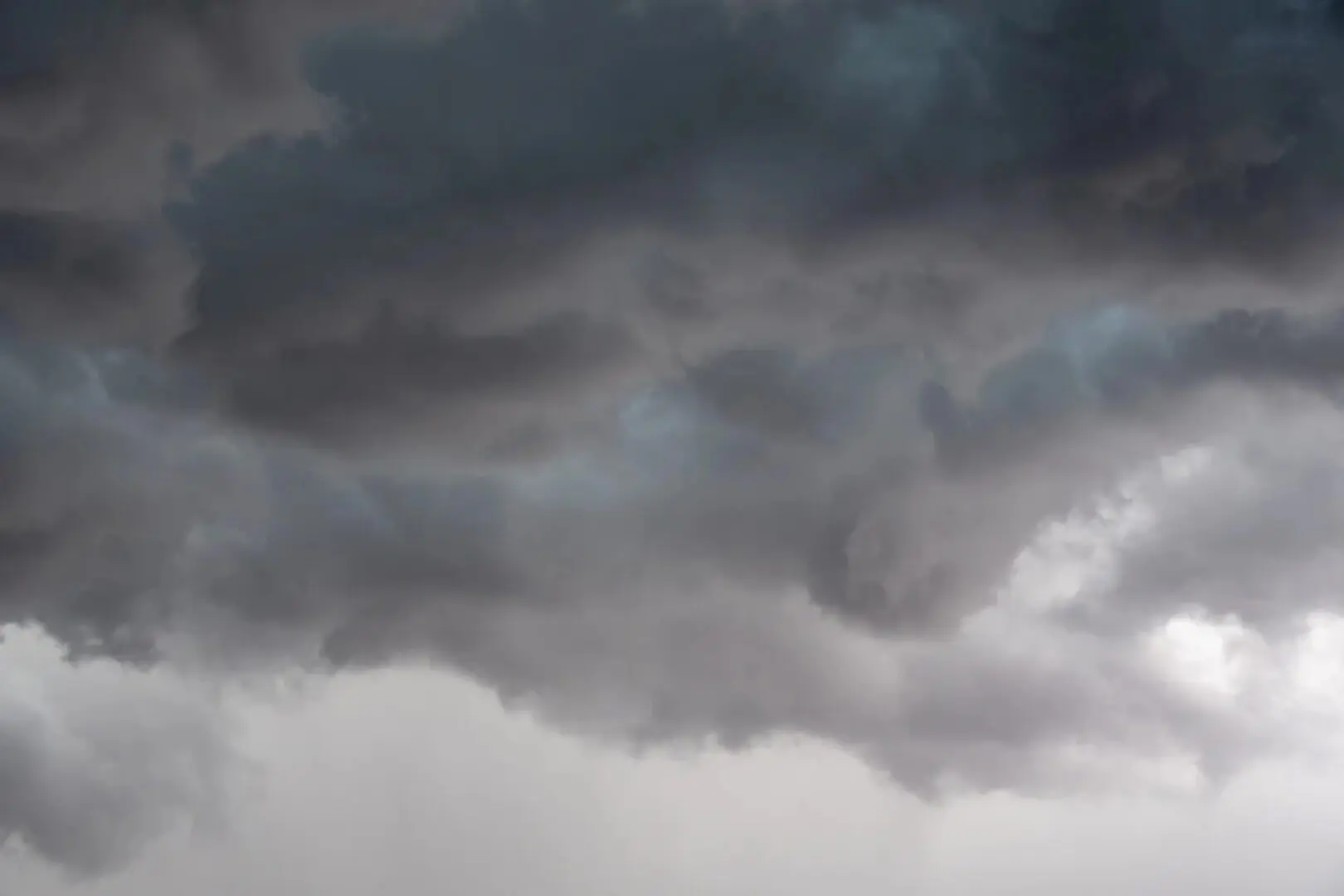 Dark stormy clouds forming in the sky, suggesting an impending rainstorm.