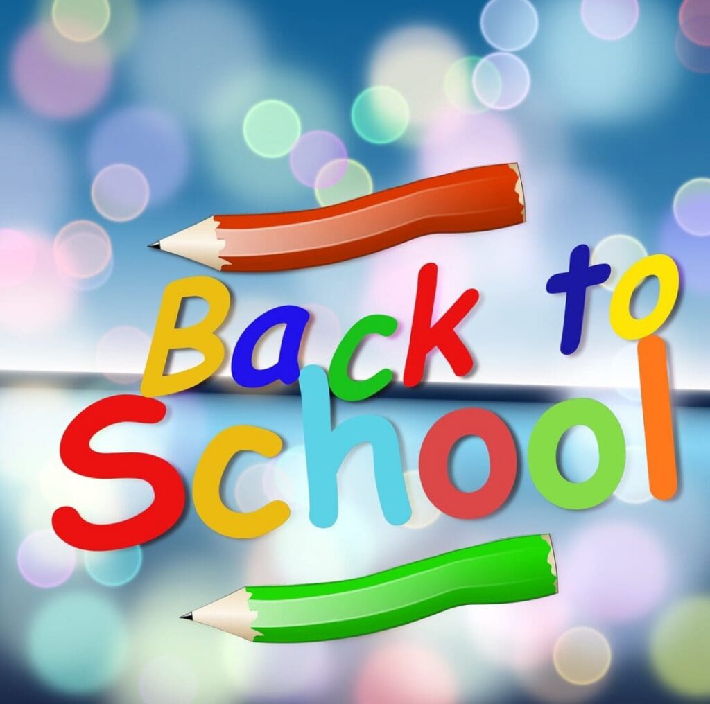 Colorful "Back to School" text with pencils and a blurred background.