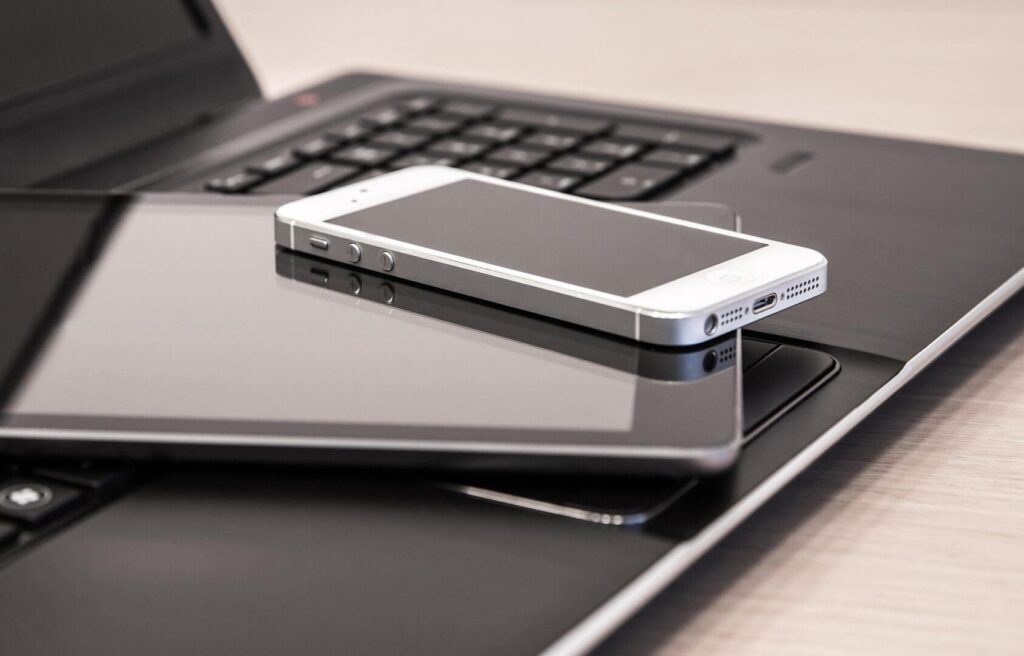 Smartphone and tablet on laptop keyboard