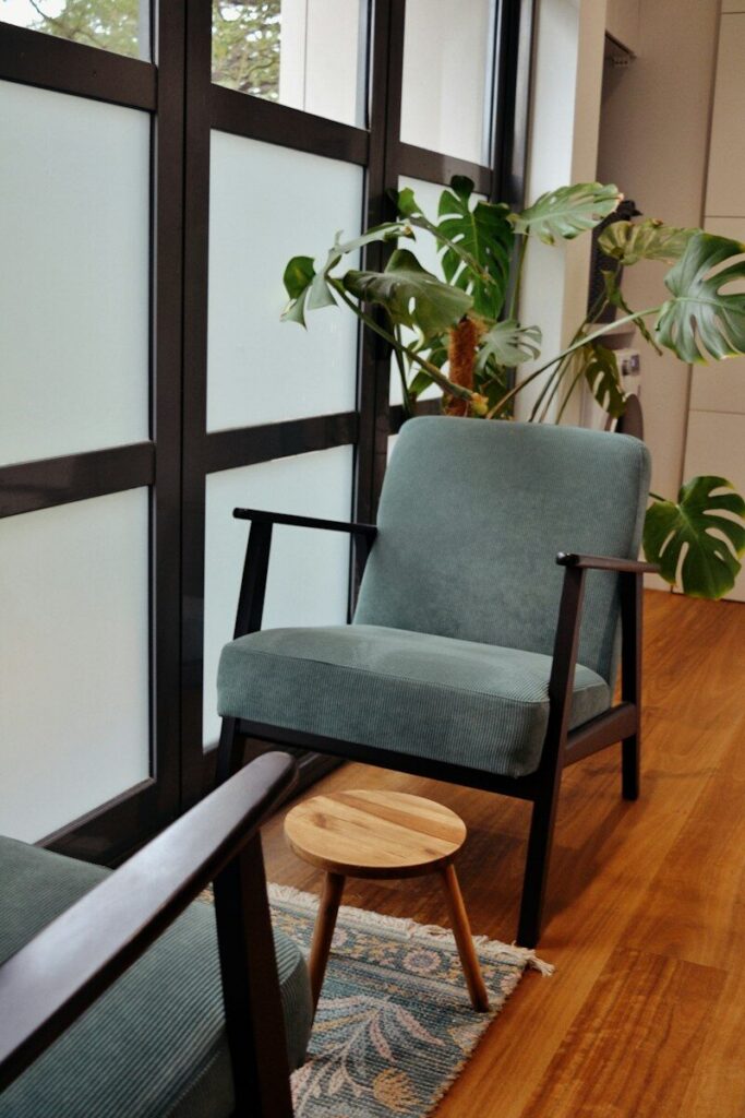 A cozy reading nook with chair and plant