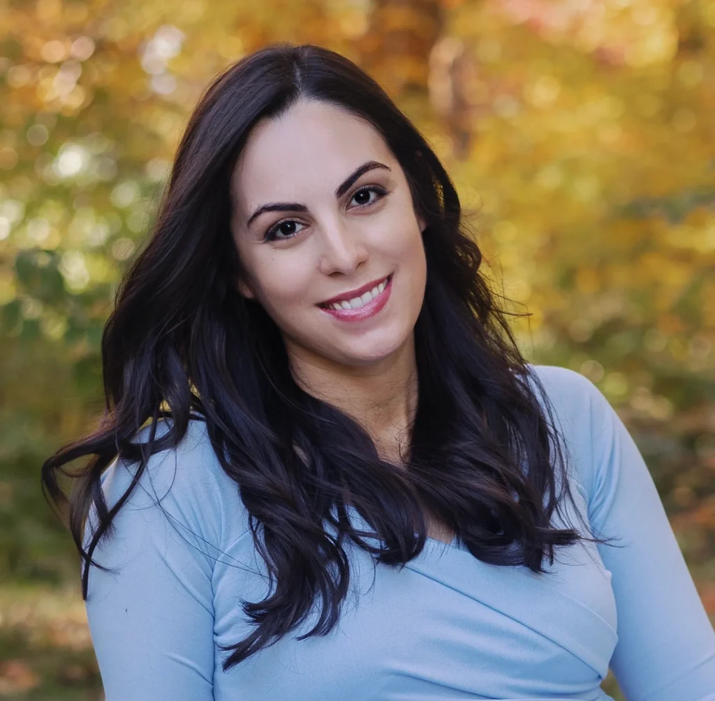 Woman smiling in autumn forest background.