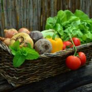 Basket of assorted fresh vegetables and herbs.